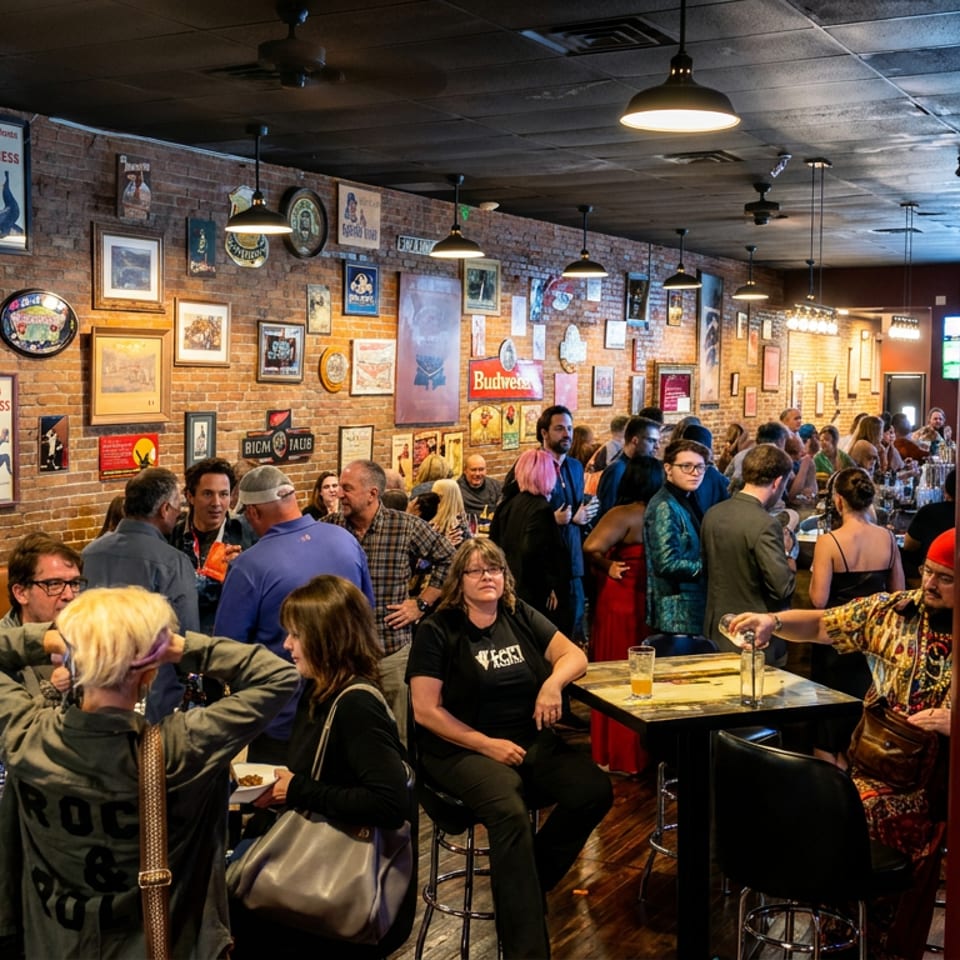 Busy Irish pub with brick walls, Guinness memorabilia, hanging lights, and patrons dining, drinking, and socializing.